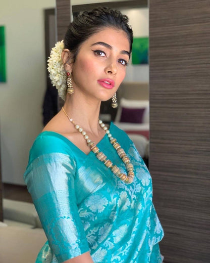 Elegant Teal Blue Silk Saree with Floral Weaving & Traditional Pearl Jewelry Look