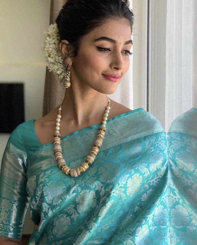 Elegant Teal Blue Silk Saree with Floral Weaving & Traditional Pearl Jewelry Look